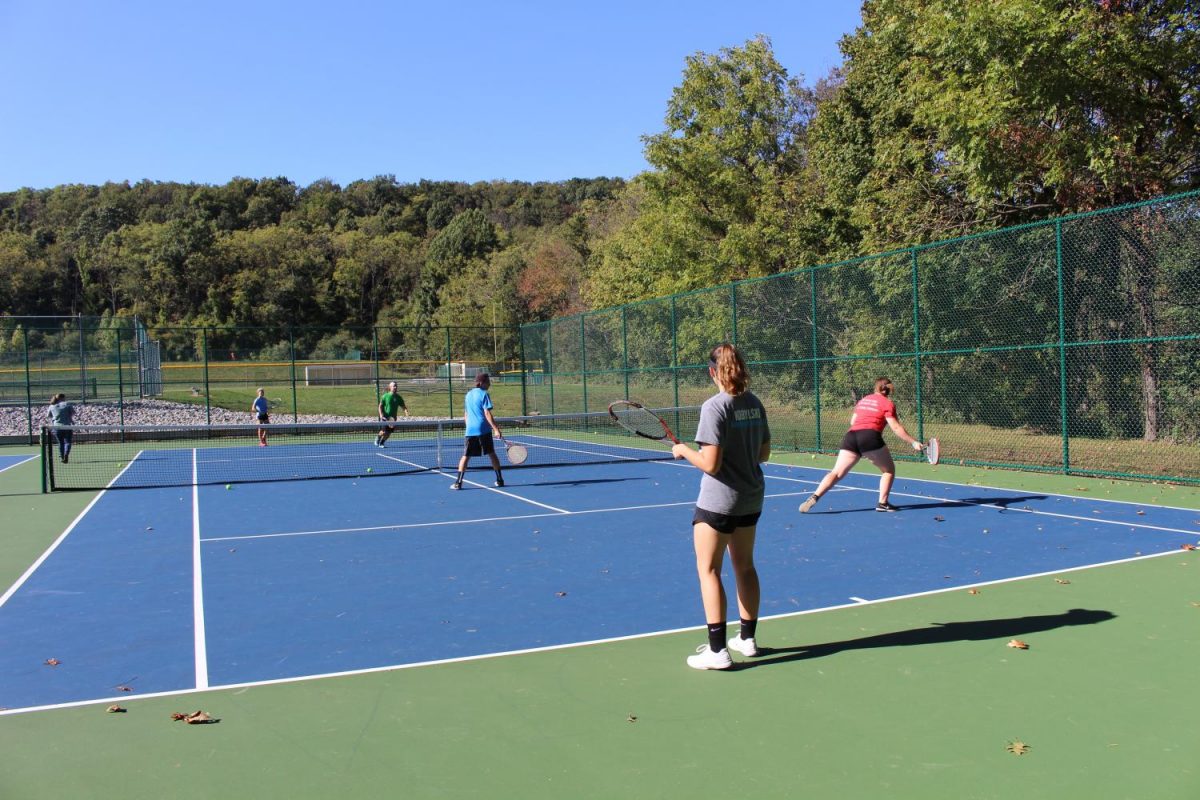 Tennis team works on playing with a partner