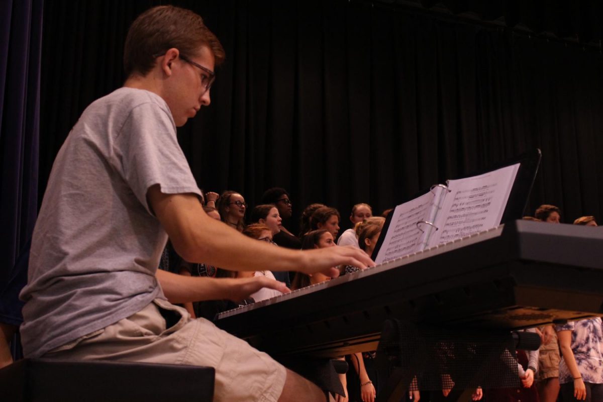 Pianist Justin Feid accompanies the choirs singing. Photo By: Lizzy Beall