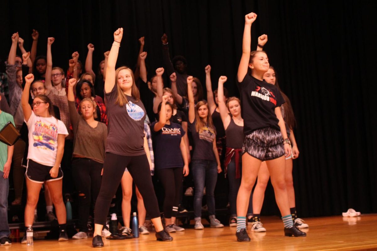 Choir strikes final pose in their practice of Step in Time. Photo By: Lizzy Beall