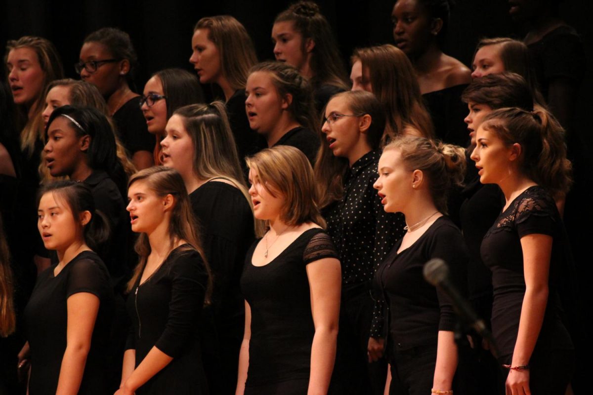 The choir sings their hearts out before the intermission. Photo By: Lizzy Beall