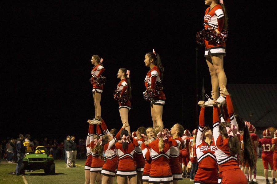 The cheerleading team performs new routines during the game. 