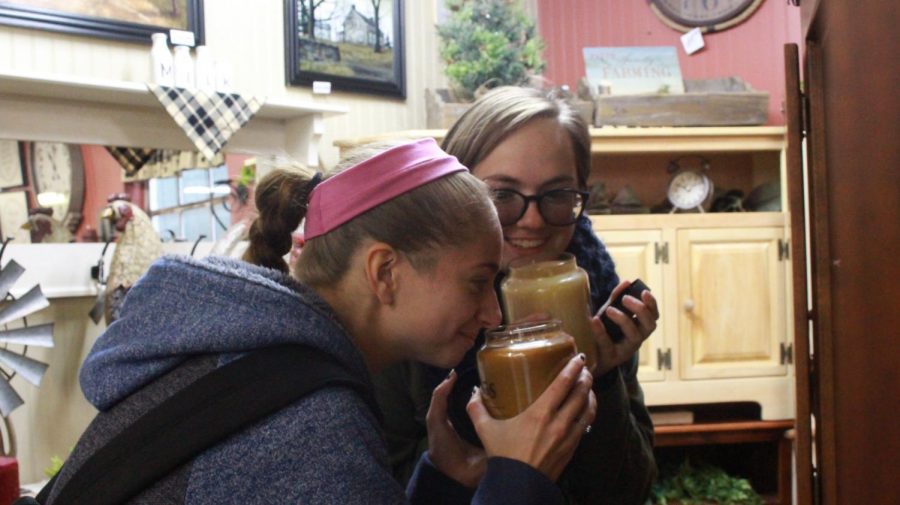 [Front to back] Juniors Sabrina Trone and Camryn Brakmann inspect candles to buy.