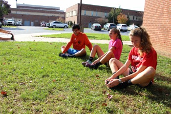 Desiree Witmer [right] does stretches with fellow runners on her team.