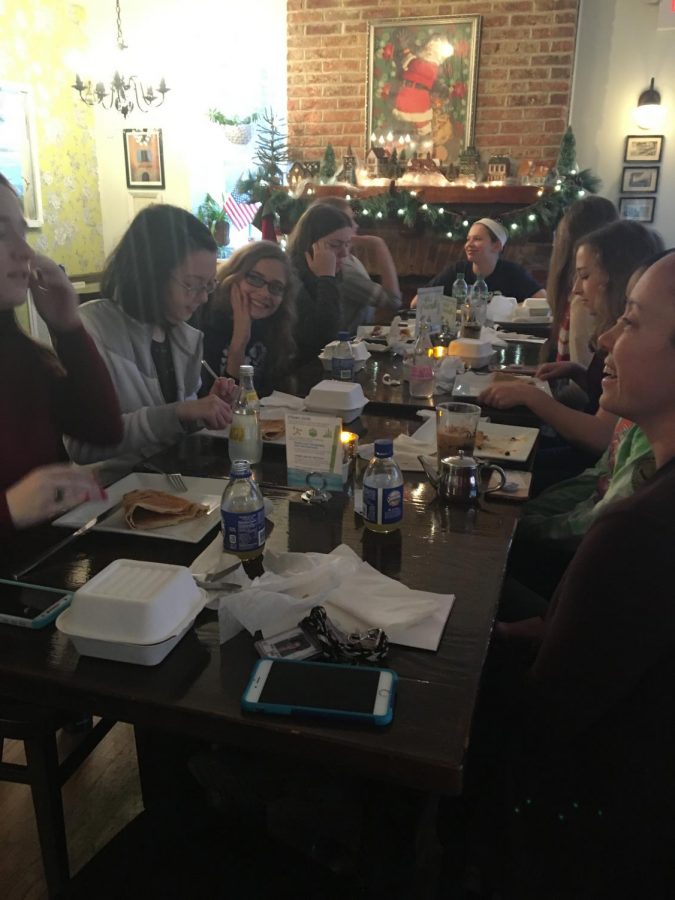 The French club enjoys eating  dessert crêpes with each other at Rachels Crepes during a field trip.
