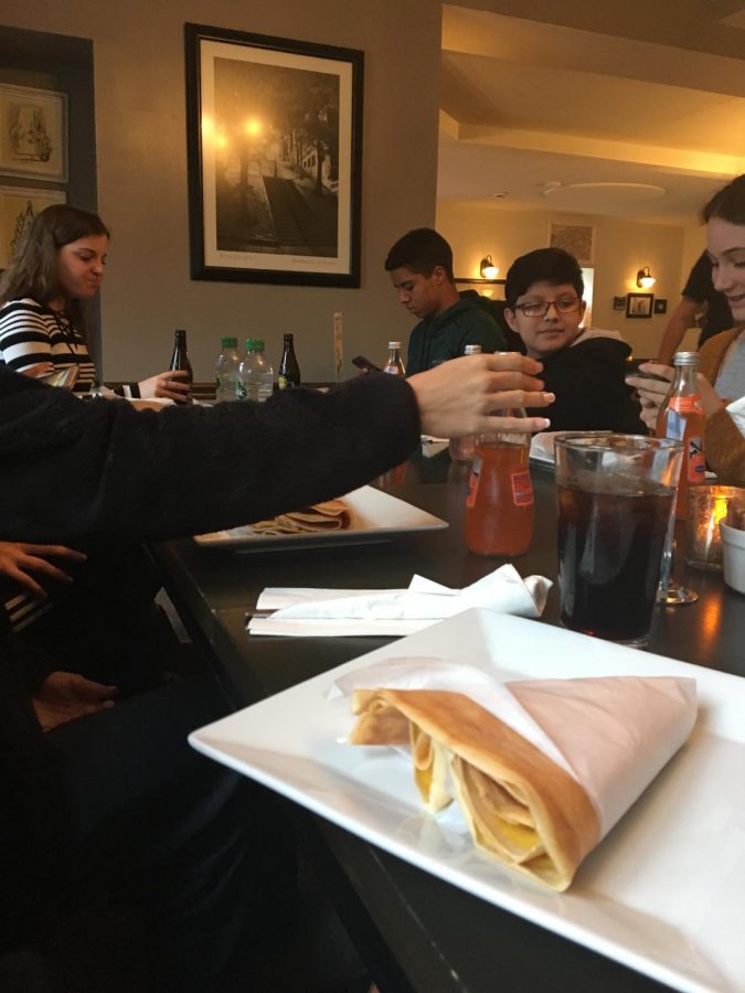The French club enjoys eating with each other at Rachels Crepes during a field trip.
