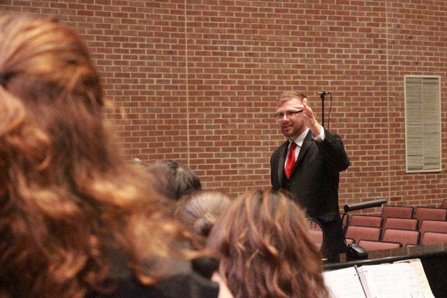 Choral director Jay Althouse gives notes to the choir before the concert. 