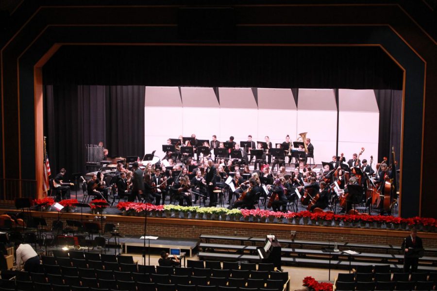 The full ensemble of the orchestra practices on stage. 