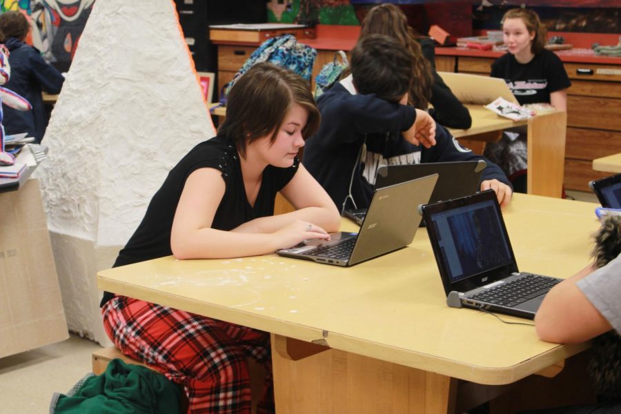 Students relax during a study hall in their pajamas. 