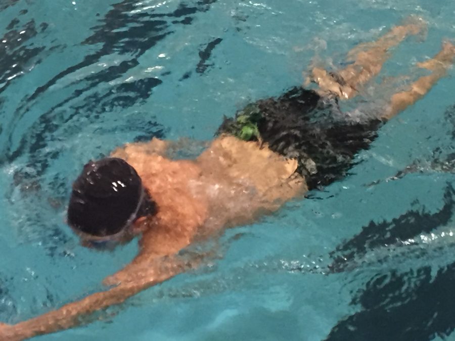 Swimmer practicing his strokes.