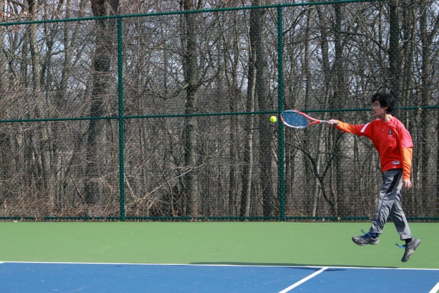 Ian McDonald is another sophomore that plays tennis. Ian is attempting to stretch and jump to hit the ball back to his opponent. 