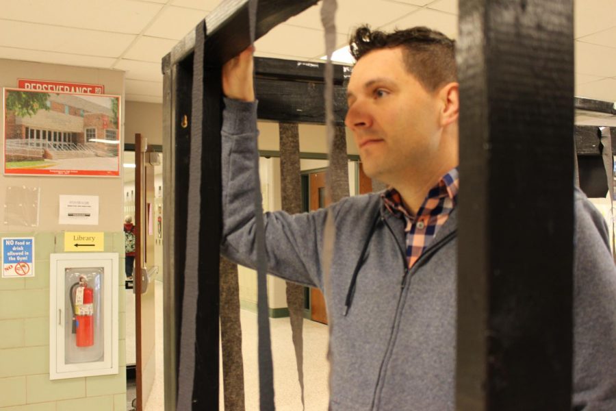History teacher Andrew Warren looks lonesomely out of the jail.