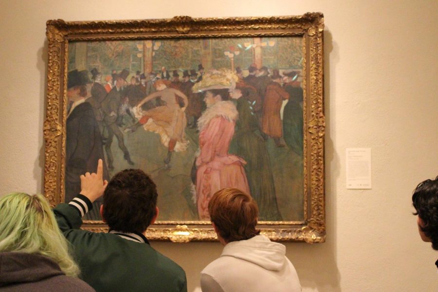 Sophomore David Wentzel points out aspects of the painting to his peers.