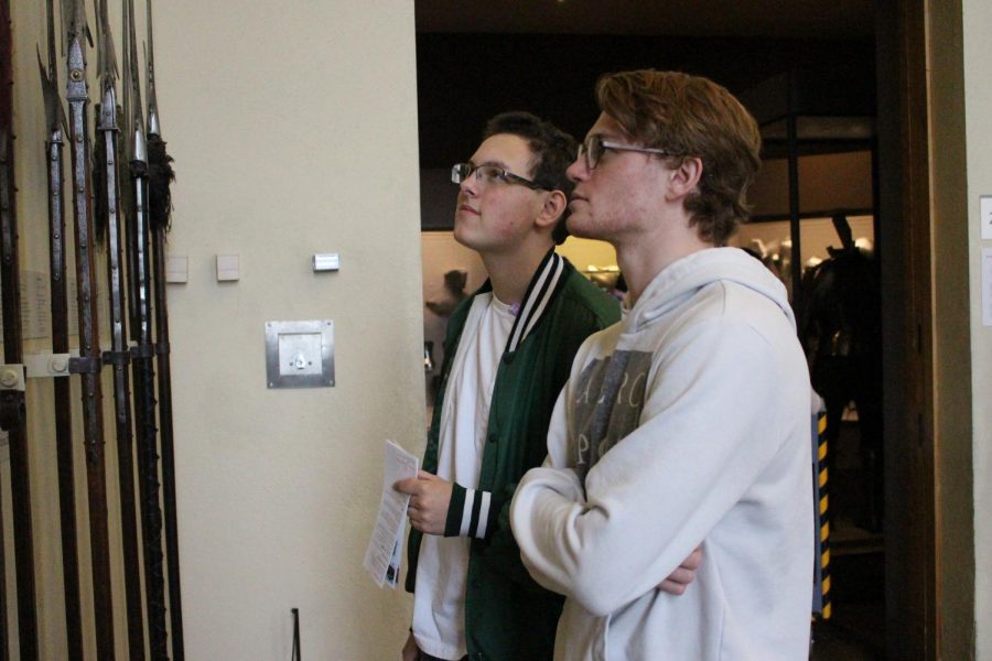 Senior Hunter Davis and sophomore David Wentzel discuss medieval weaponry as they look upon spears used in that time. 