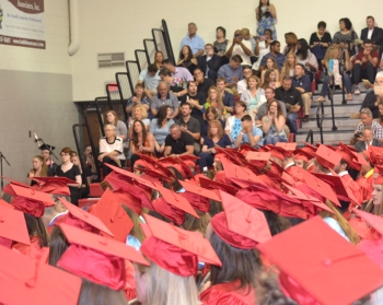 Students standing at graduation. 