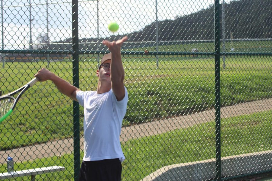 Marin Thomas serves a tennis ball at one of the teams practices. 
Photo by: Michael Daiuto