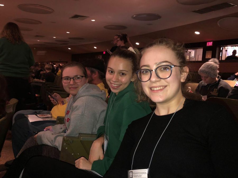 (From left to right) Seventh-grader Cordelia Jenkins, junior Sophia Wetzel and senior Lily Stockbridge prepare to watch a show in the auditorium. 
