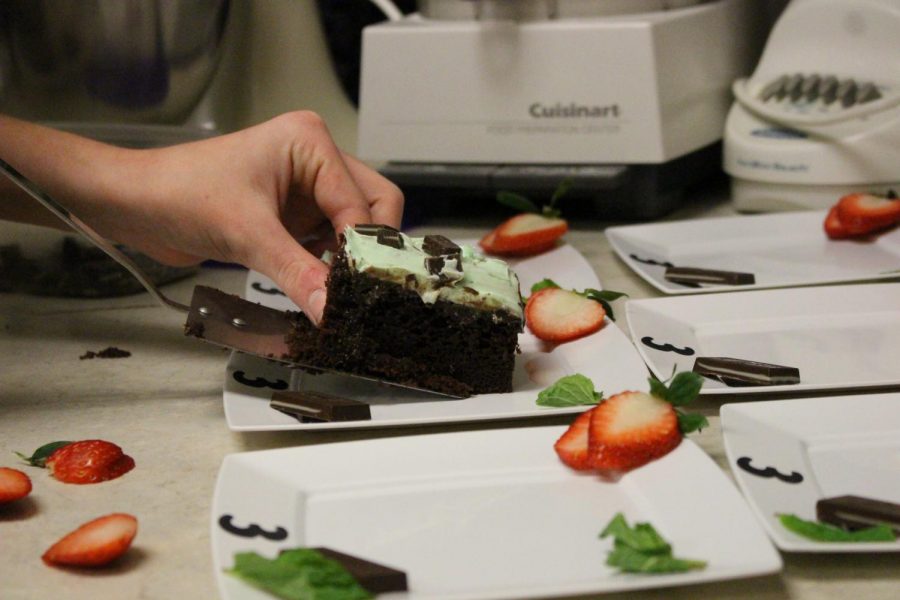A student carefully places their dessert to maximize presentation. This was for the annual Iron Chef competition in the foods class. For period 7/8, three dessert dishes competed against one another; strawberry shortcake, tiramisu, and grasshopper cake shown above. 