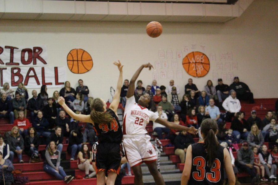 Senior Jaden Walker (22) won the tip-off at the beginning of the game.  Walker scored her 1000 points a week prior to this game, but that achievment wont stop her from putting in effort for the rest of the season. 
Photo by Abby Paterniti