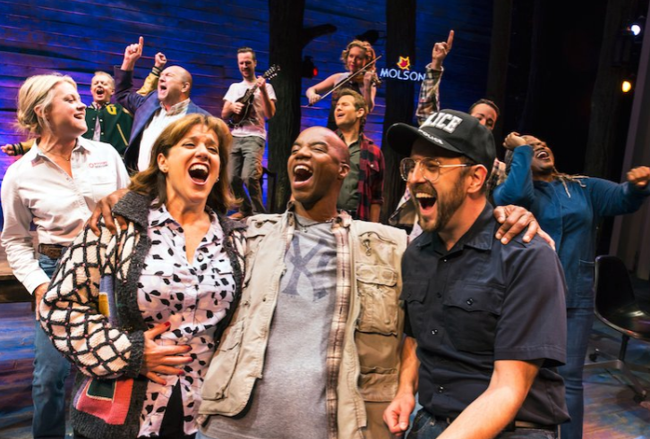 The cast of Come From Away sings.