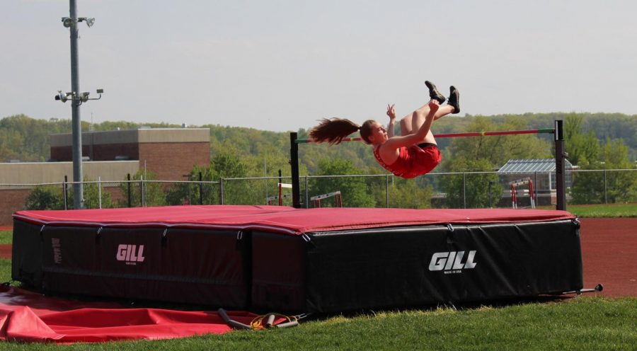 Junior Noel Laven participates in the high jump. Laven tied with teammate Courtney Burgess for first place with a jump of 4 6.