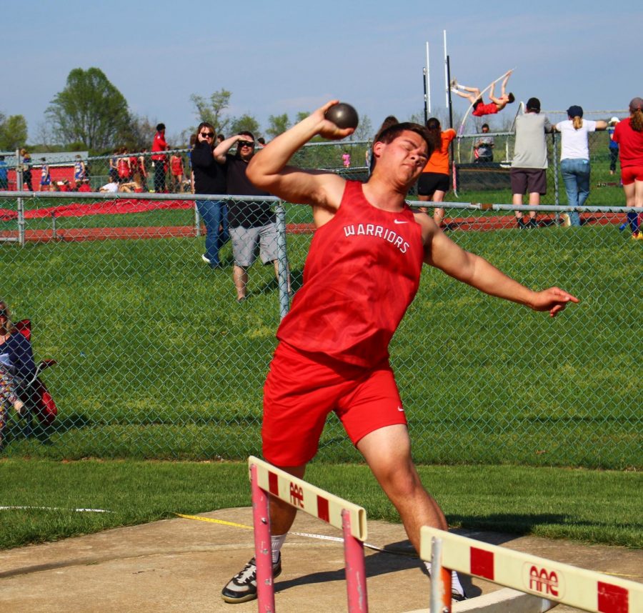 Junior Brock Hofler makes an attempt in shot put in the meet against Kennard-Dale. “The discus and shot put are heavier this year, so it’s hard for me to improve my distance because they’re heavier. There was a new one, javelin, which I have never thrown before.” said Elsen on the difference between middle and high school track. 
