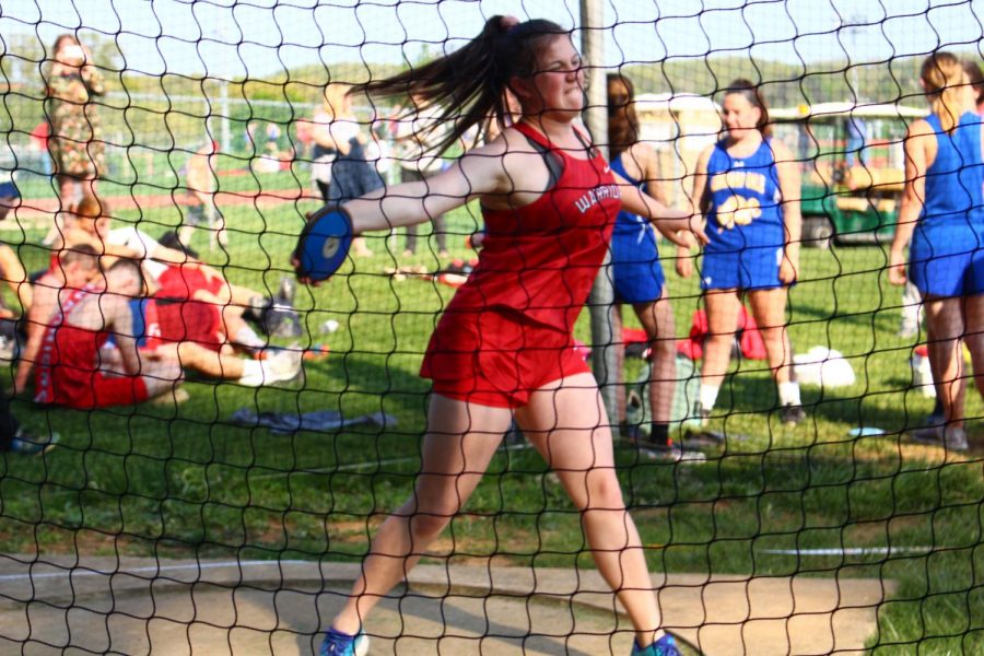 Freshman Andrea Hammond throws the discus in the Kennard-Dale meet. Hammond finished in second place with a distance of 64 10. She placed first in the shot put with a distance of 29 10. For the season, the boys track and field team finished with a regular season record of 5-2, while the girls went 6-1. 