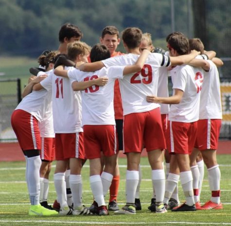 The boys in the pregame huddle before the start of a game this season.
