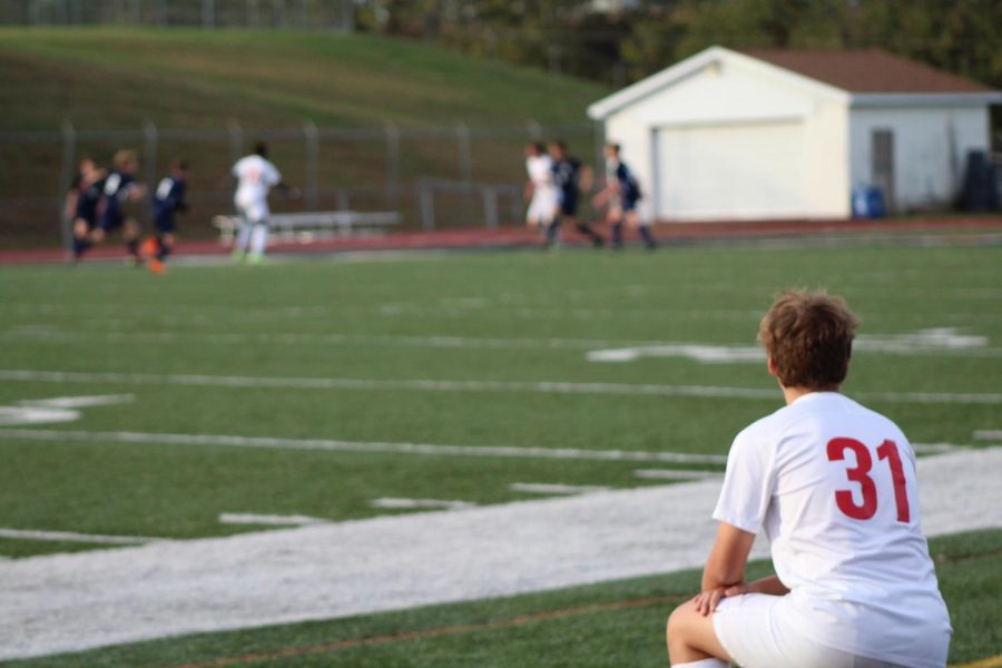 Sophomore Ashton Murray watches on the sideline as he prepares to enter the game. 
Photo by Ava Holloway
