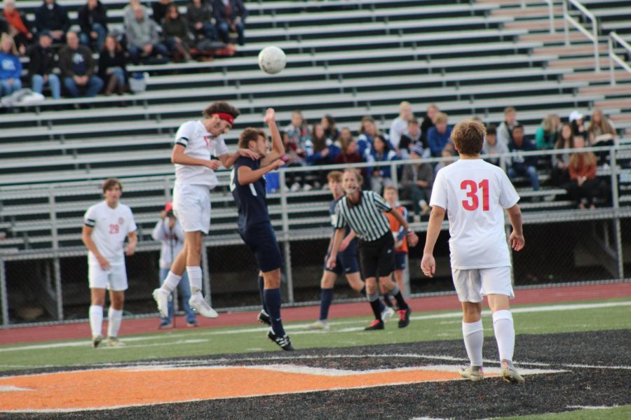 Senior Captain Nolan Holloway jumps in the air for a header. 
Photo by Ava Holloway.