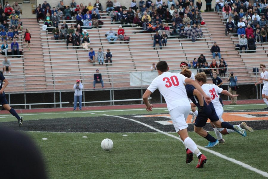 Murray chases down the ball and prepares to dish it out to Senior Jon Lippy.
Photo by Ava Holloway.