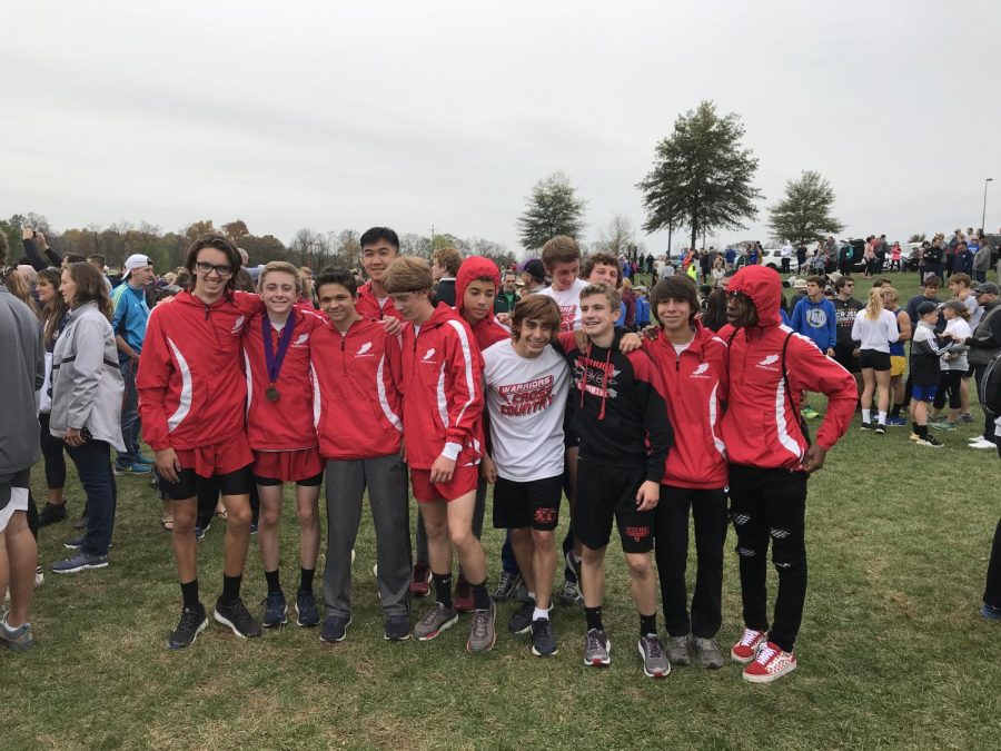 The Warriors boys cross country team smiles after qualifying for the state tournament.  Photograph by Jim Lebo