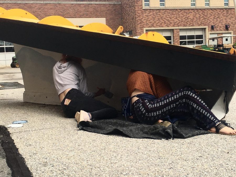 Seniors Randee Semlar and Anna Joy working under their snow plow. 

Photo By: Wade Bowers