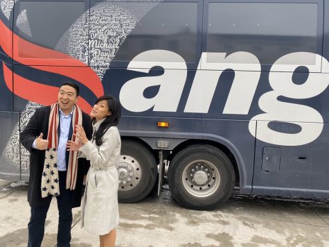 Andrew Yang smiles with his wife in front of the Yang bus. Photograph @AndrewYang via Twitter