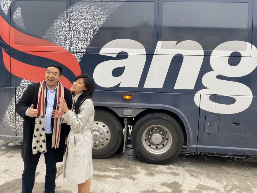 Andrew Yang smiles with his wife in front of the Yang bus. Photograph  @AndrewYang via Twitter