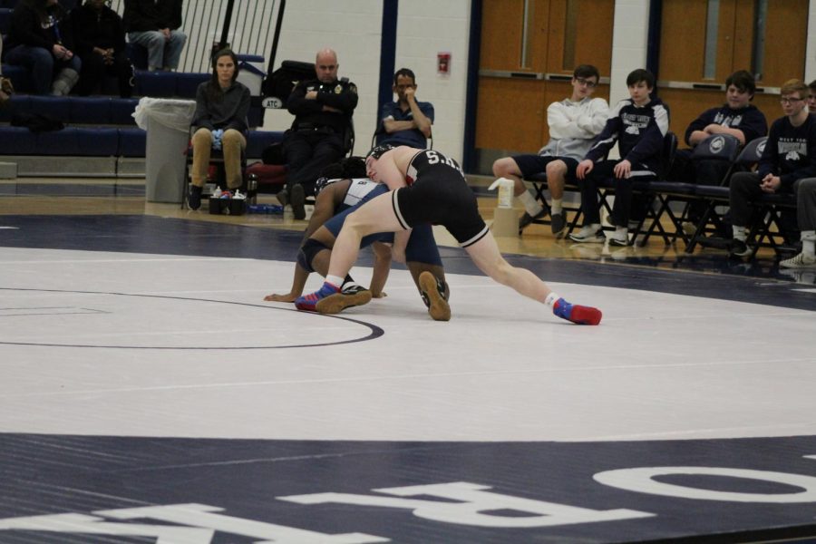 Senior wrestler, and team captain, Colby Romjue wrestles his opponent on the road at West York on Jan. 23. Photograph by Mackenzie Womack.