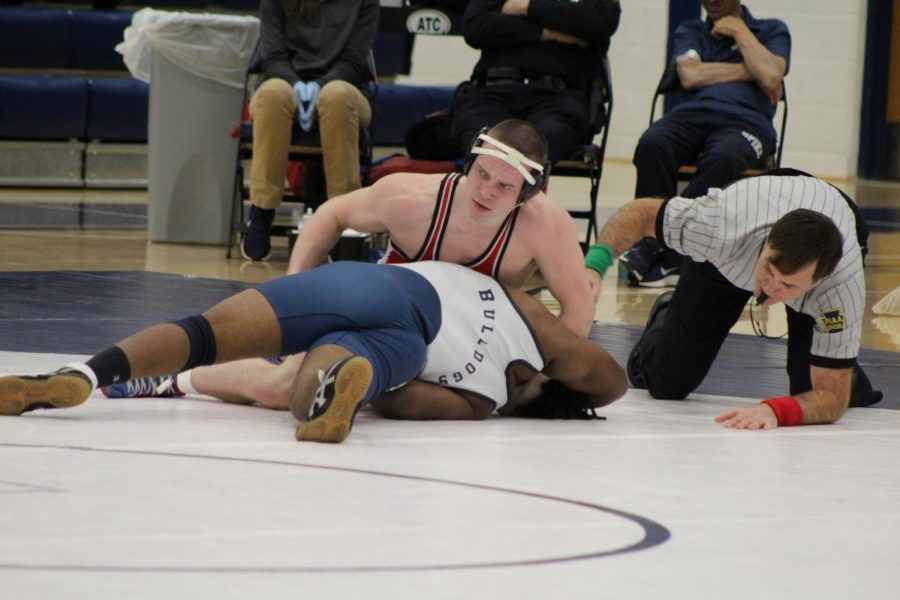 Romjue maneuvers his way around his opponent in order to complete the pin. Photograph by Mackenzie Womack.