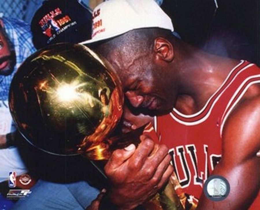 Michael Jordan cherishes the Larry OBrian Trophy after he won his first NBA Finals in 1991 after beating the Los Angeles Lakers. 

Photograph by @paveibure24 via Twitter