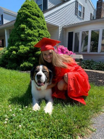 Senior Amber McClure posing for a picture with her dog.