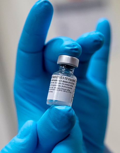 A doctor holds a vial of the BioNTech COVID-19 mRNA vaccine. Photo by U.S. Secretary of Defense, CC BY 2.0 , via Wikimedia Commons