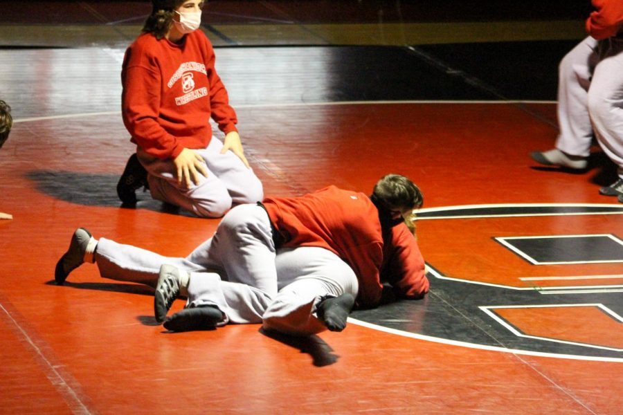 Freshmen Jack VanTassel and Micheal Fox and sophomore Tristan Coleman warm up prior to the wrestling teams match against the Hanover Nighthawks on Jan. 27.
Photograph by Tricia Rawleigh