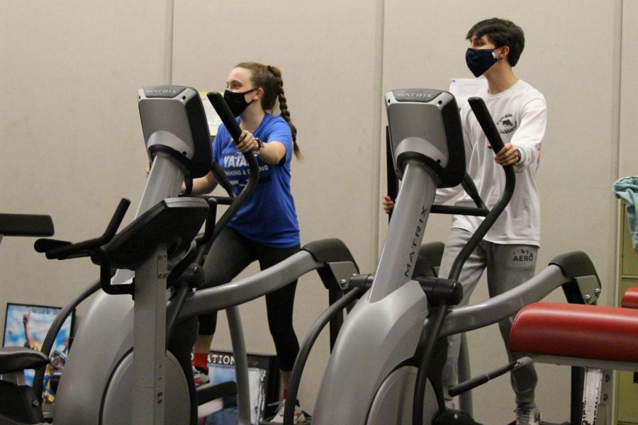 Sophomores Kylie Martin and Michael Snyder hit the weight room to exercise for track and field. Photograph by Alexa Viands