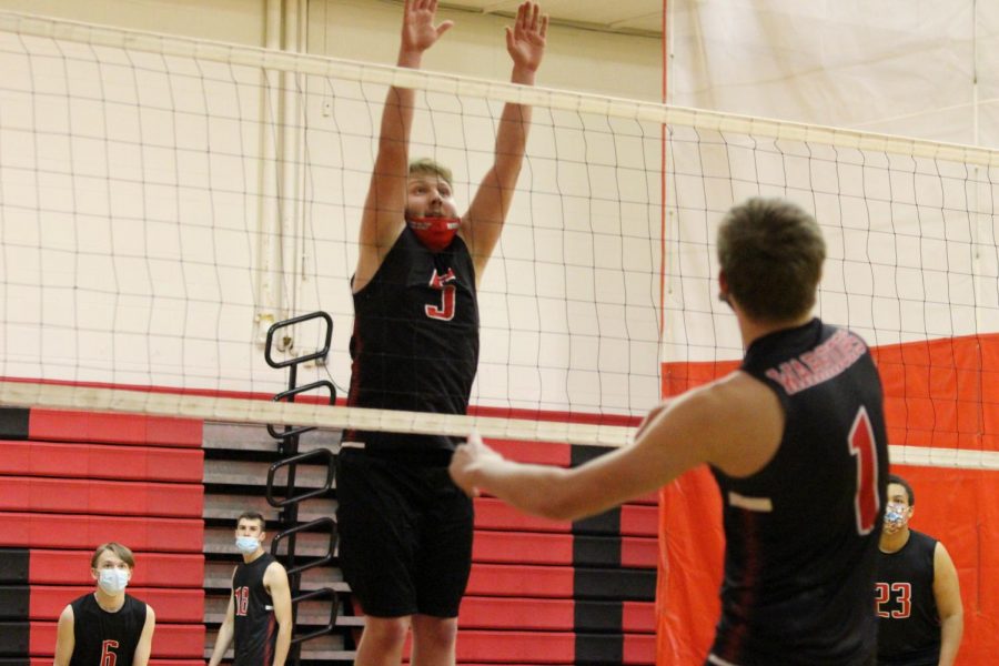 Senior Tyler Evans blocking a hit from senior Andrew Fuller during practice, preparing for the upcoming scrimmage.
Photograph by Alexa Viands