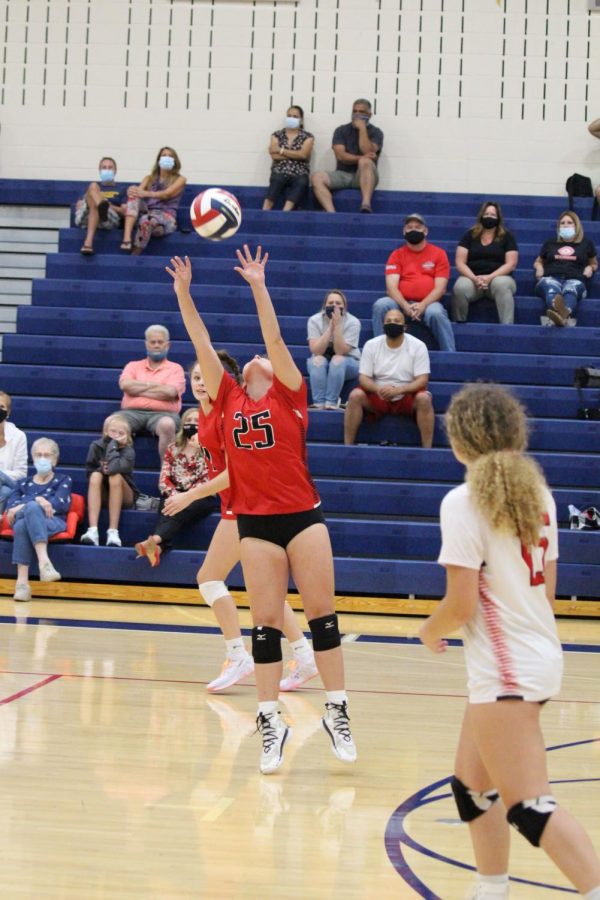 Freshman Claire Somerville sets the ball to get a point for the lady Warriors. Photograph by Tricia Rawleigh