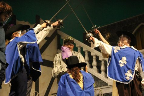  DArtagnan, played by Camille Rowe, is knighted by the King, played by Cooper ODonnell, while the other Musketeers and Sabine salute. The three Musketeers were played by Jillian Geppi, Caroline Dumm and Kyle Billings, while Julliana Quintilian portrayed Sabine. 
Photograph by Alexa Viands