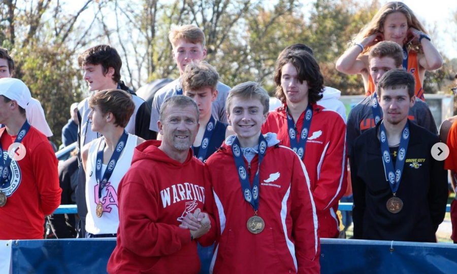 Cross Country coach Jim Lebo and OBrien pose for a picture after OBrien receives his medal from the State Championships. Photograph via @mattobrien on Instagram. 