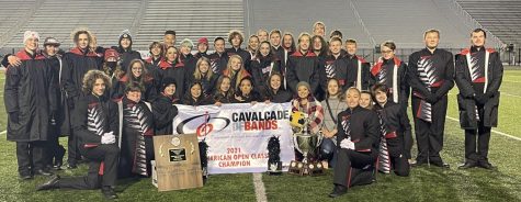The marching band poses one last time with their accolades after they won championships. Photograph by Chalet Harris
