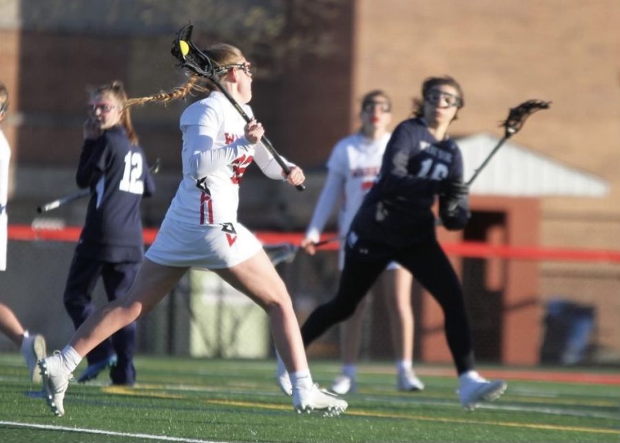 Marusko takes a shot on the goal against West York. On April 19, the Warriors beat the Bulldogs 22-3 and Marusko scored her 100th career goal. Photograph via @brookebosphoto on Instagram. 