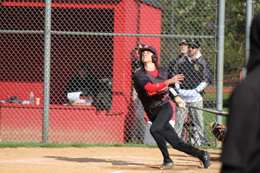 Joshua Pecunes drives the ball in the outfield for a double. Photograph by Mackenzie Womack 