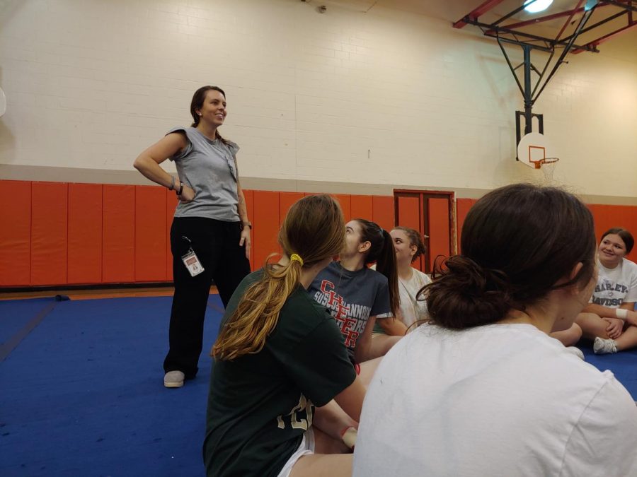 Cheer coach Krista Herbert talks to her team during  practice. photographed by Tim Hare