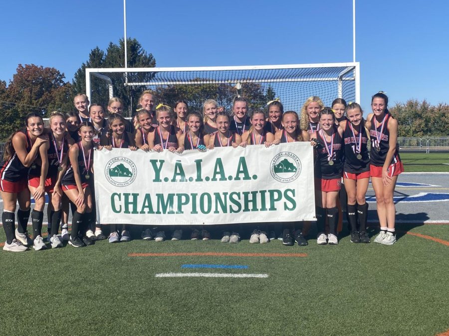 The field hockey team holds up a celebratory banner after winning the Y.A.I.A.A. championships. Photograph by @SuskyWarriors via Twitter
